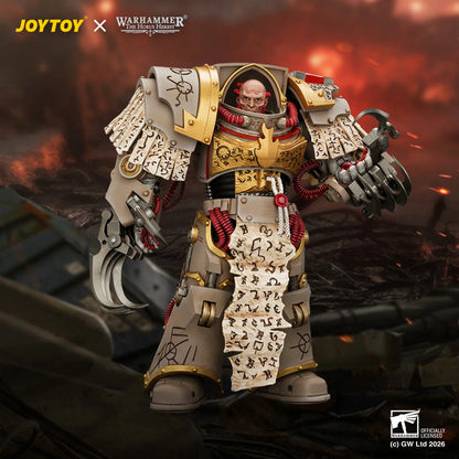 A detailed collectible figure of a Warhammer 40k Space Marine in ornate white and gold armor, holding a scroll with runic symbols, set against a dramatic fiery battlefield background. Brand logos for JOYTOY and Warhammer 40k are visible.