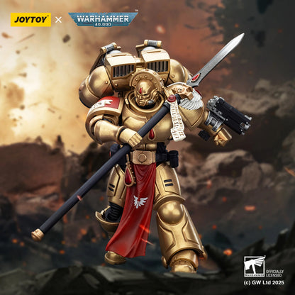 Toy figure of a warrior in gold armor with a sword and gun, branded with Joytoy and Warhammer.