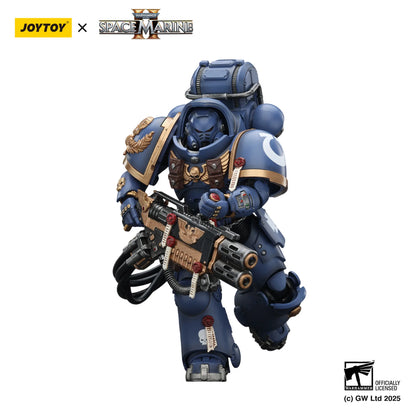 Toy figure of a Space Marine in blue armor with a weapon, branded with Joytoy and Games Workshop logos.