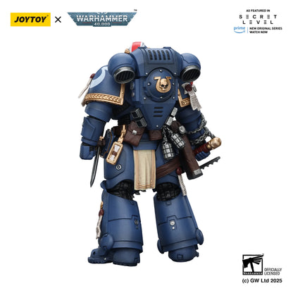Toy figure of a character from Warhammer 40,000 on a white background with JoyToy and Warhammer branding.